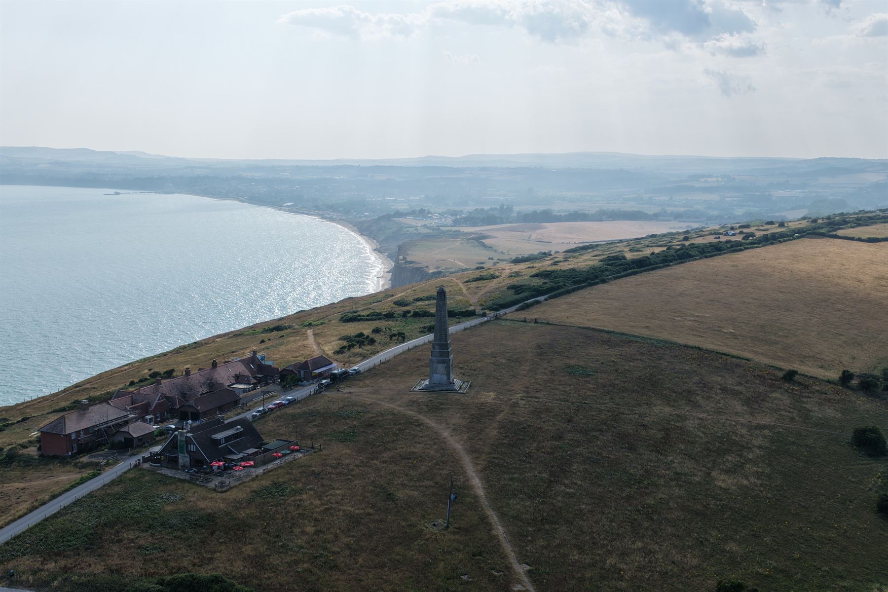 Aerial photograph over Culver Down on the Isle of Wight, the chalk headland and monument above a sweeping bay